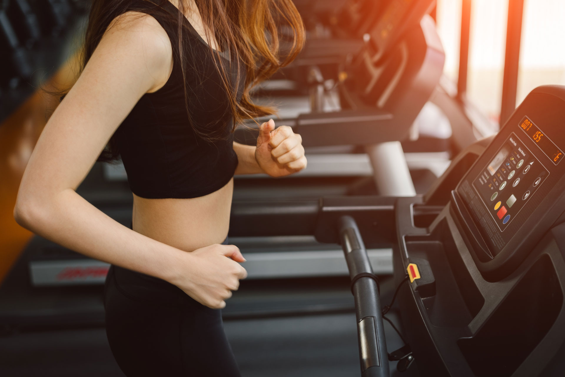 Women running on a treadmill in a fitness room